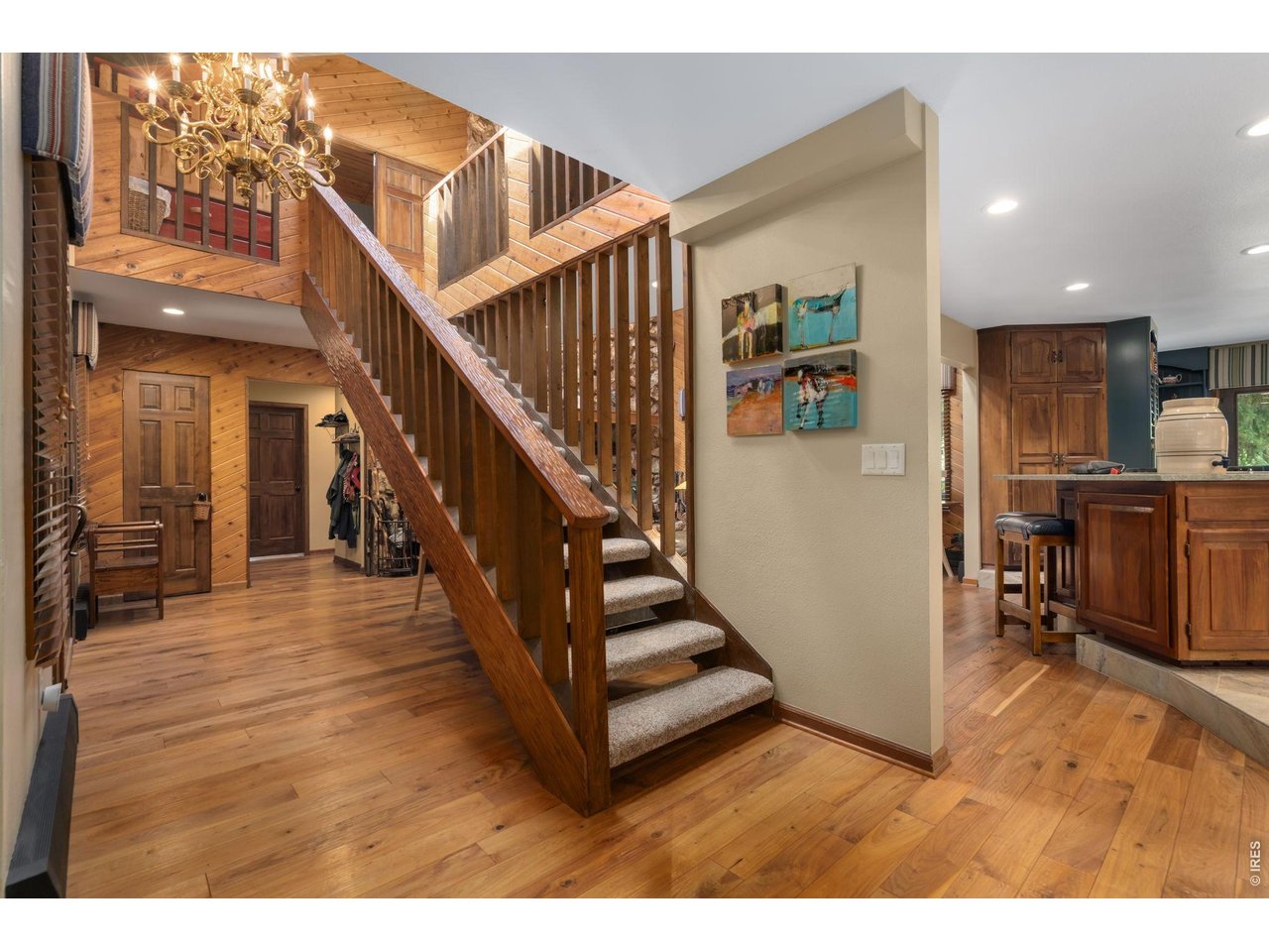 View of entry way and staircase to second level. Hand-scraped black walnut wood floors