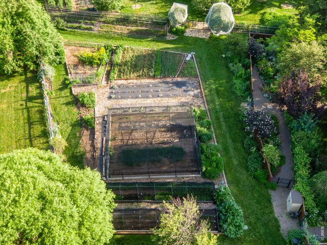 Property Photo 9 Vegetable Garden, Herb Garden, and Strawberry Patch and covered Cherry Trees