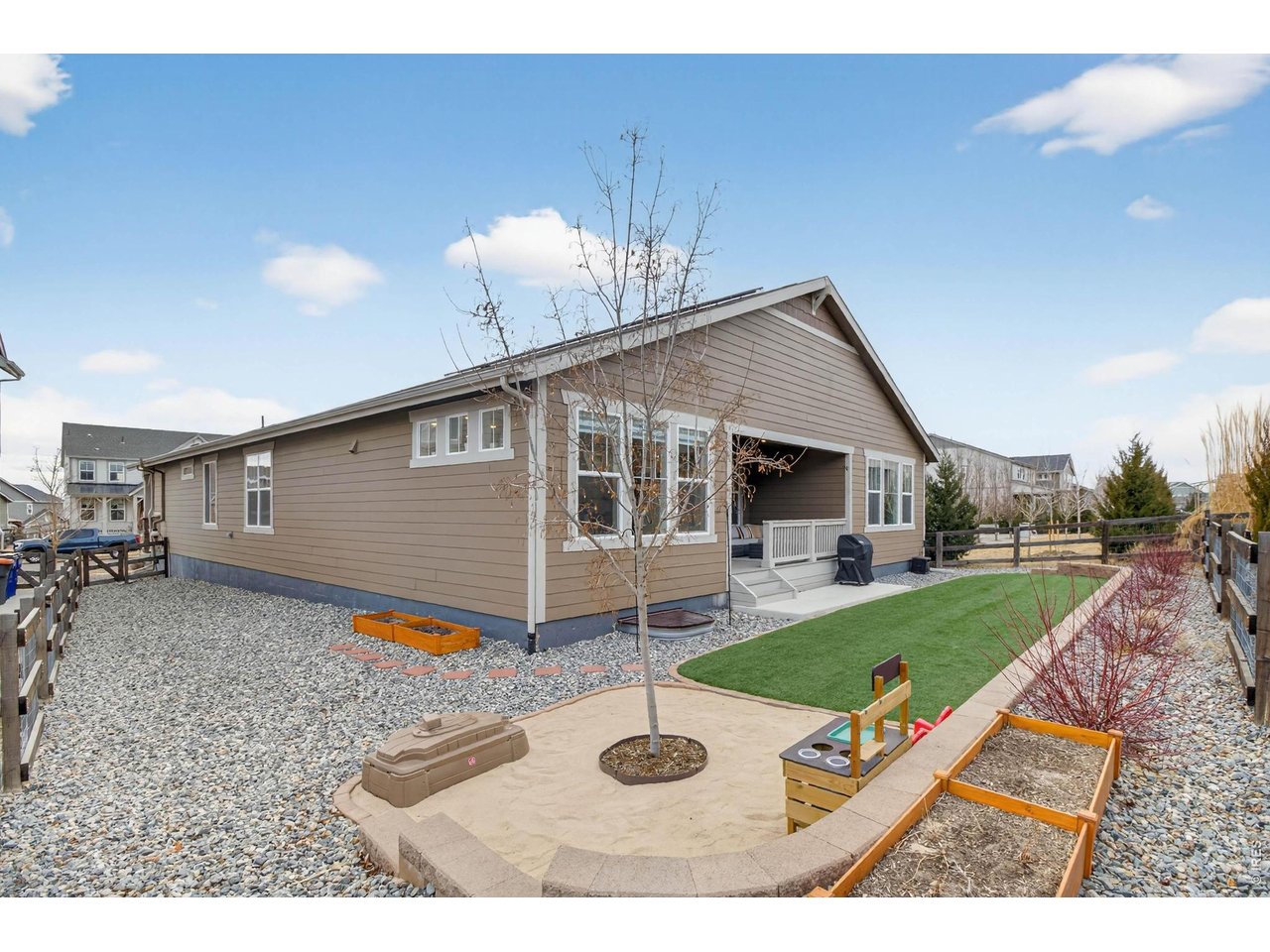 meticulously landscaped exterior, complete with a sand pit and artificial turf (green yard all year round!)