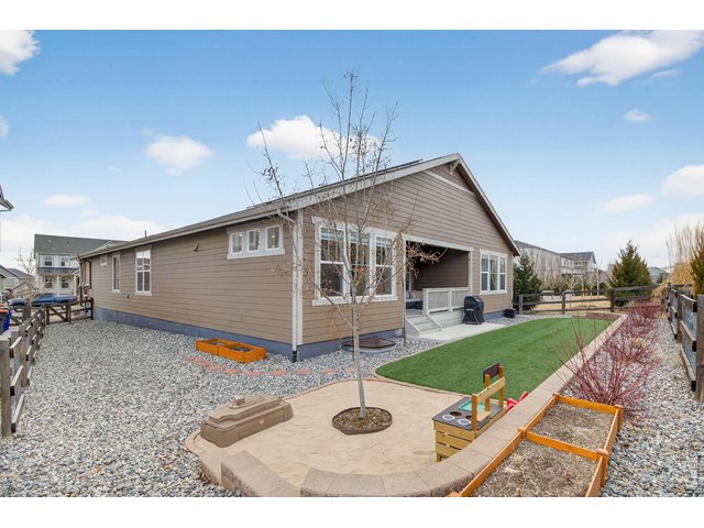 Property Photo 36 meticulously landscaped exterior, complete with a sand pit and artificial turf (green yard all year round!)