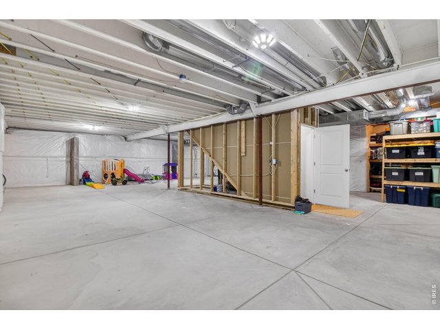 Property Photo 31 Unfinished basement is identical footprint to the main level, shelving units stay