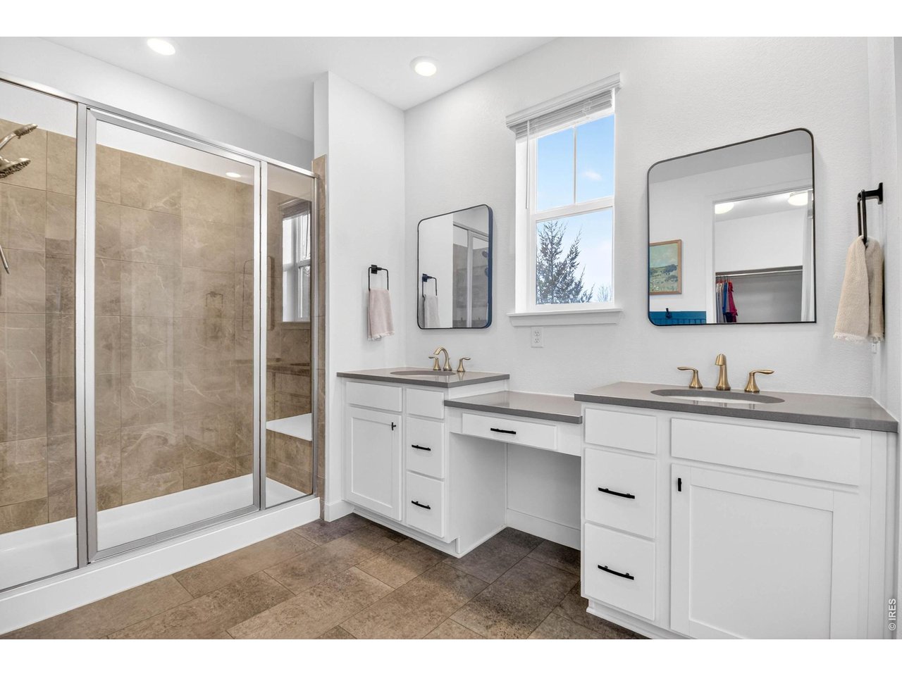 dual vanities, walk-in shower with bench seating
