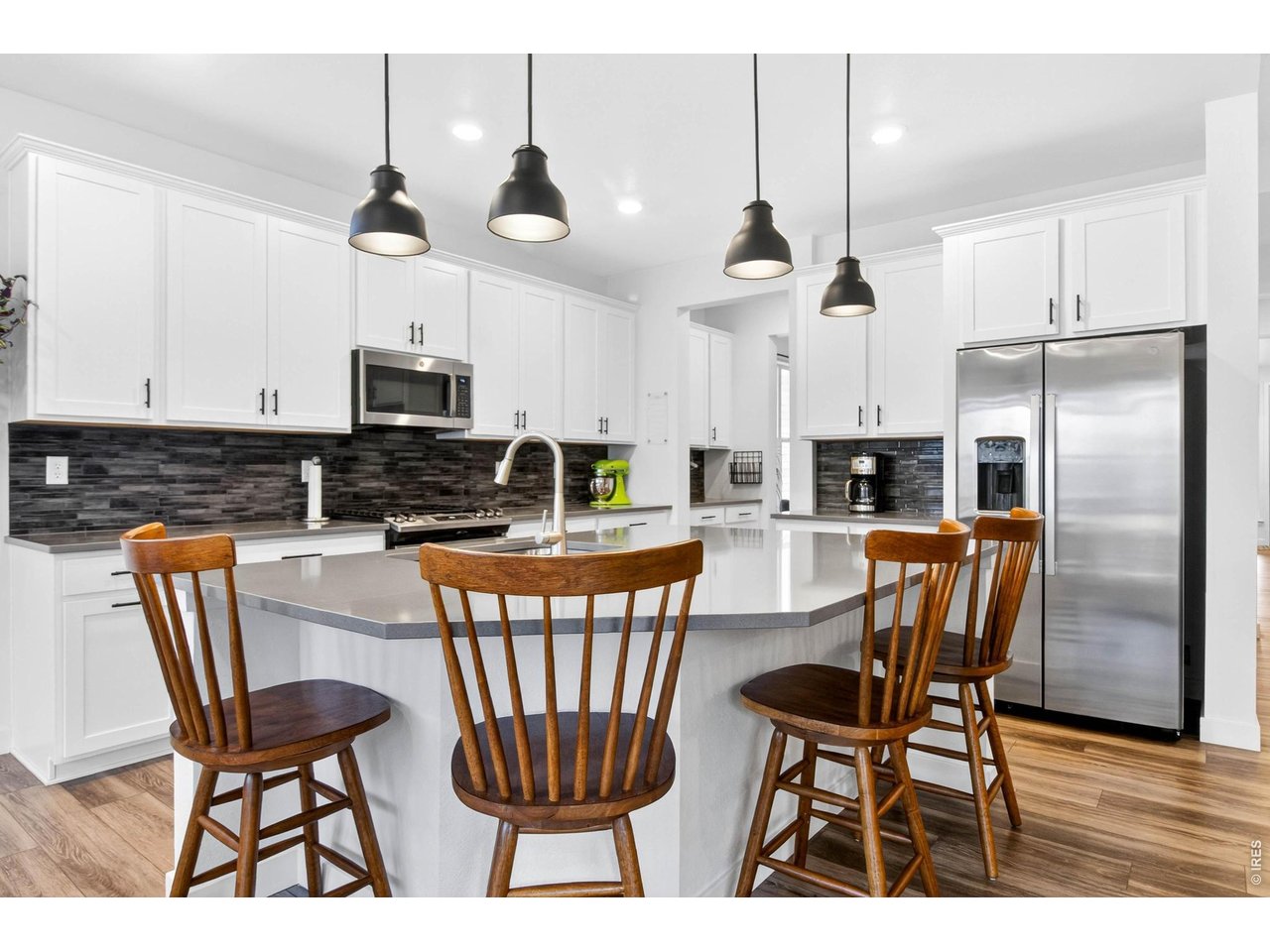 stainless steel appliances, quartz countertops, and custom tiled backsplash