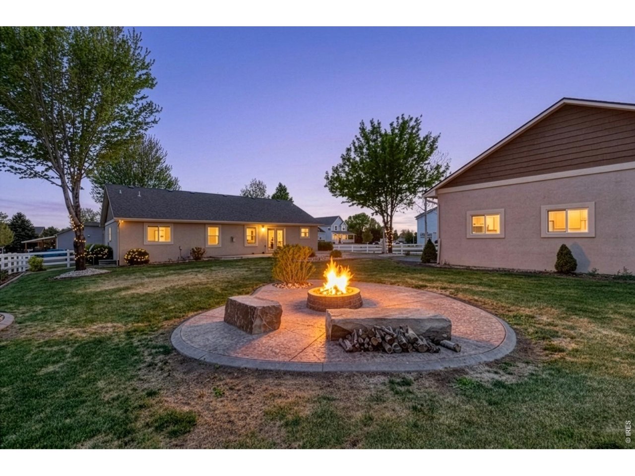 The backyard is built for enjoying Colorado living with mature trees, a spacious 550 sq ft stamped patio, and a dedicated firepit area perfect for entertaining on summer evenings.