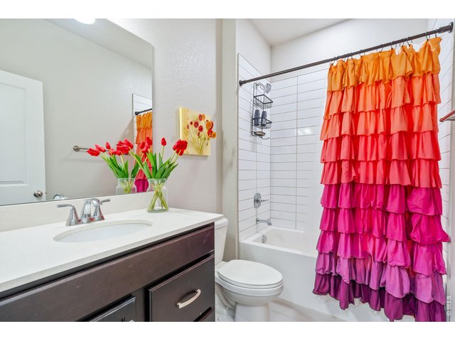 Property Photo 19 Main full bathroom with a beautifully tiled bathtub.
