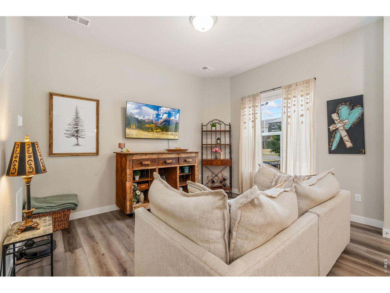 Spacious living room with large windows and neutral finishes