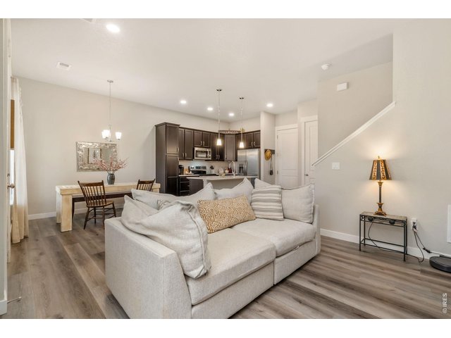 Property Photo 4 Bright living space flowing seamlessly into the kitchen and dining area