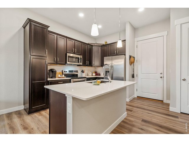 Property Photo 8 Kitchen with plenty of cabinets, pantry storage, and island seating