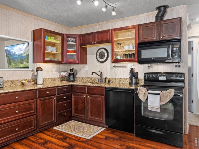Property Photo 6 Granite counters and wood flooring