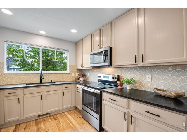 Property Photo 12 Added Hickory to the kitchen flooring - interlaced to match and all Hickory HW floors were redone in 2024. 