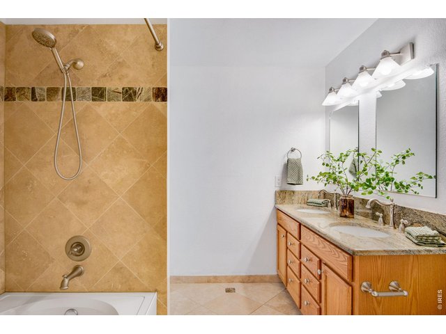 Property Photo 25 Full Primary Bathroom, beautiful Tile work throughout and convenient heated floors. 