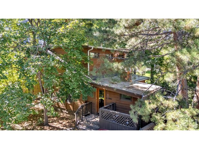 Property Photo 1 surrounded by mature trees 