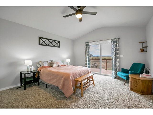 Property Photo 19 Primary suite with vaulted ceilings and access to the back deck