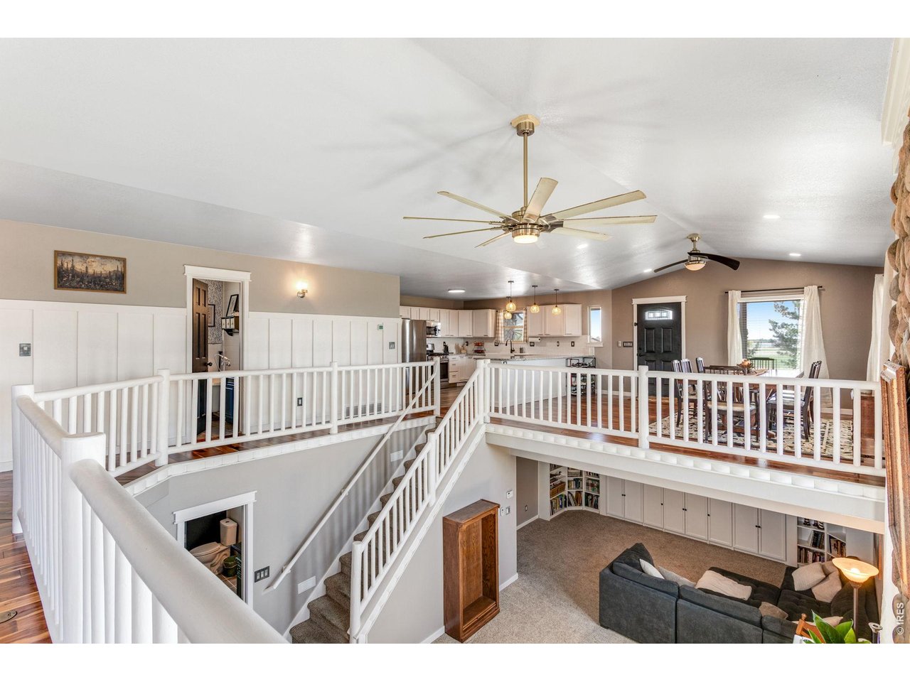 Across from the kitchen and dining room is living room with a stunning view of the living space below giving this space a very open feel and lots of natural light.