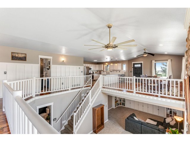 Property Photo 14 Across from the kitchen and dining room is living room with a stunning view of the living space below giving this space a very open feel and lots of natural light.