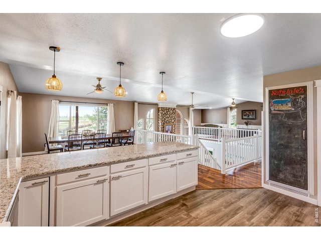Property Photo 8 Kitchen - View of dining room and opening to family room on the lower level.