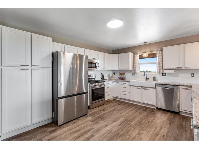 Property Photo 6 Kitchen - 15'x13' gives plenty of room to move around in the updated kitchen with new granite countertops. All appliances are included