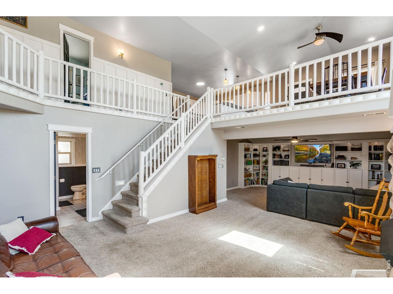 Looking into the den with the built-in wrap around shelving