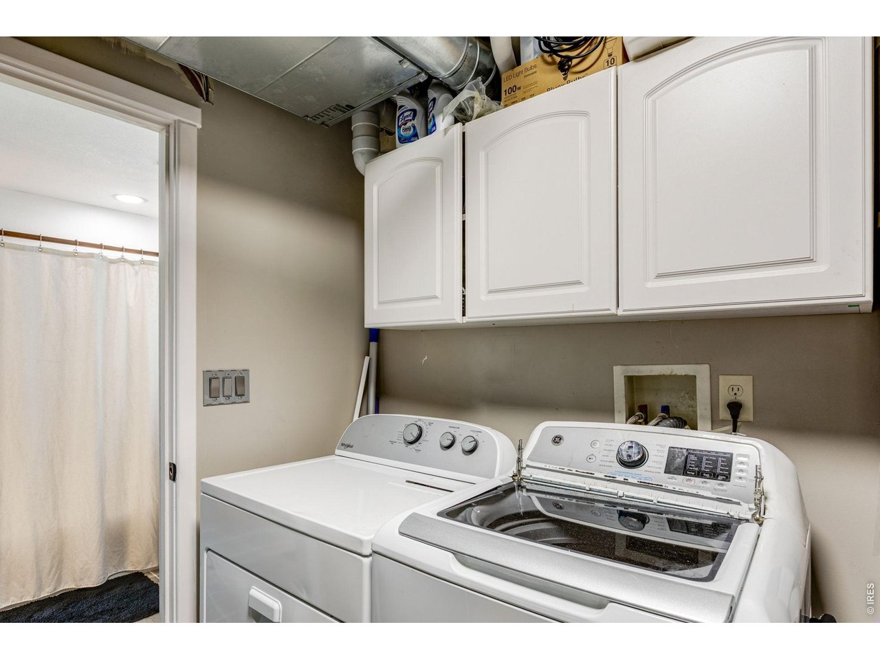 Laundry is next to shared primary bathroom on lower level.