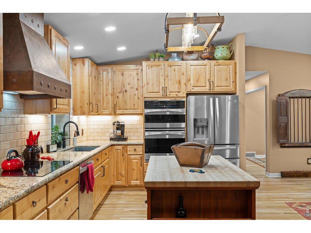 Addition of new upper wooden cabinets for more storage. Stainless steel double oven and fridge/freezer. 