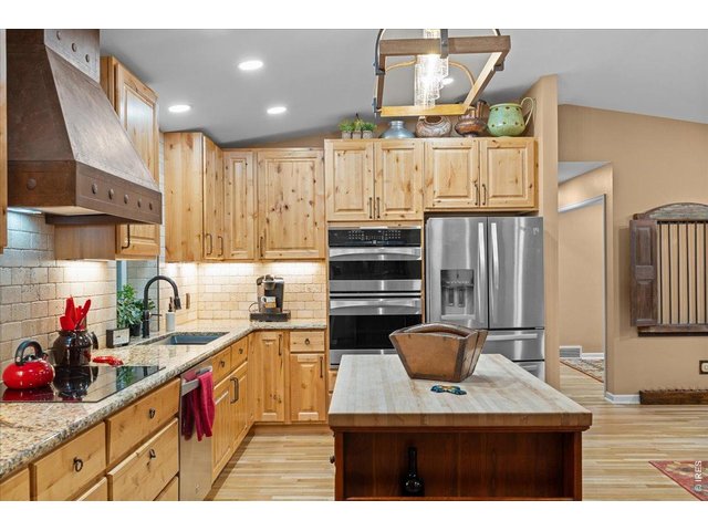 Property Photo 9 Addition of new upper wooden cabinets for more storage. Stainless steel double oven and fridge/freezer. 