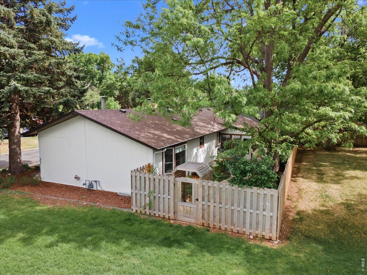 Gate with an antique wrought iron window with access directly to the greenbelt. 
