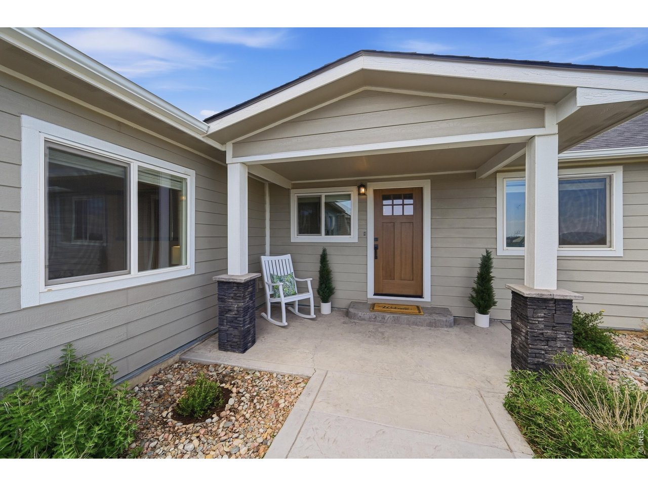 Stamped concrete invites you to a covered porch.