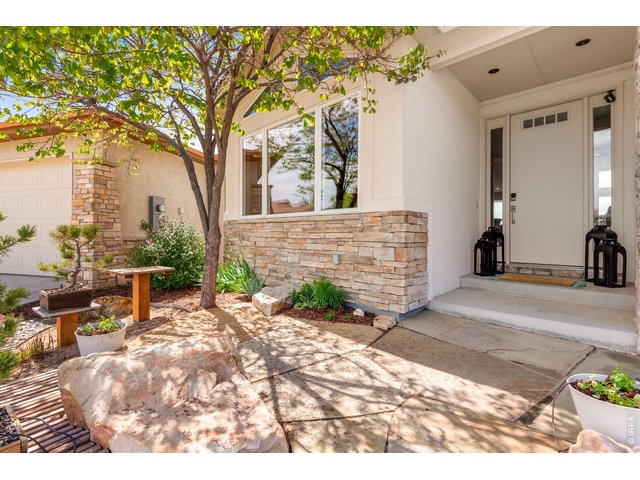 Property Photo 16 Welcome, beautiful flagstone entry and comfortable covered front porch and a beautiful RedBud tree to greet you! 