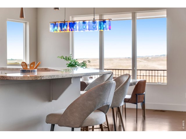 Property Photo 26 Check out this massive slab Granite island, gaze out to miles of unobstructed views! 