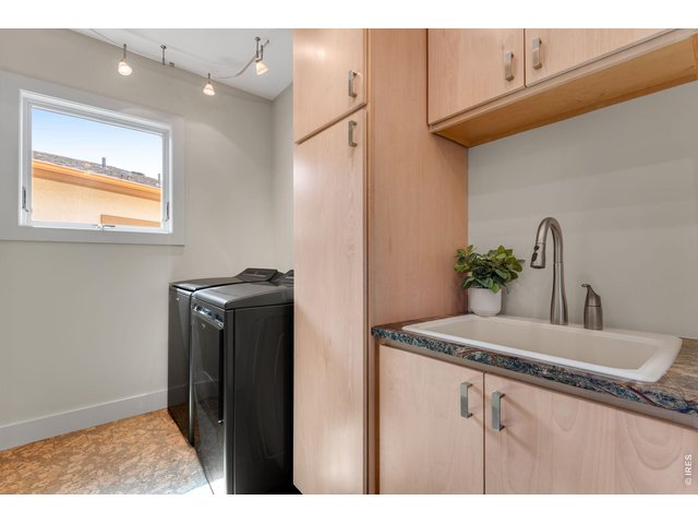 Property Photo 35 Main Level Laundry, Quark floors W/D 2024 and included, maple cabs and rainforest marble countertop and convenient utility sink! 