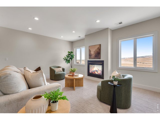Property Photo 43 Spacious Lower Level Family Room, perfect for games, relaxation and enjoy over 180 degress of prairie and rocky mountain views! 