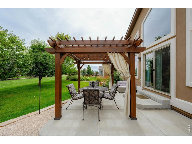 Property Photo 33 Charming Outdoor Sitting Space & Extended Patio! Mature Trees line the Back of the Property Line for Extra Privacy & Beauty!