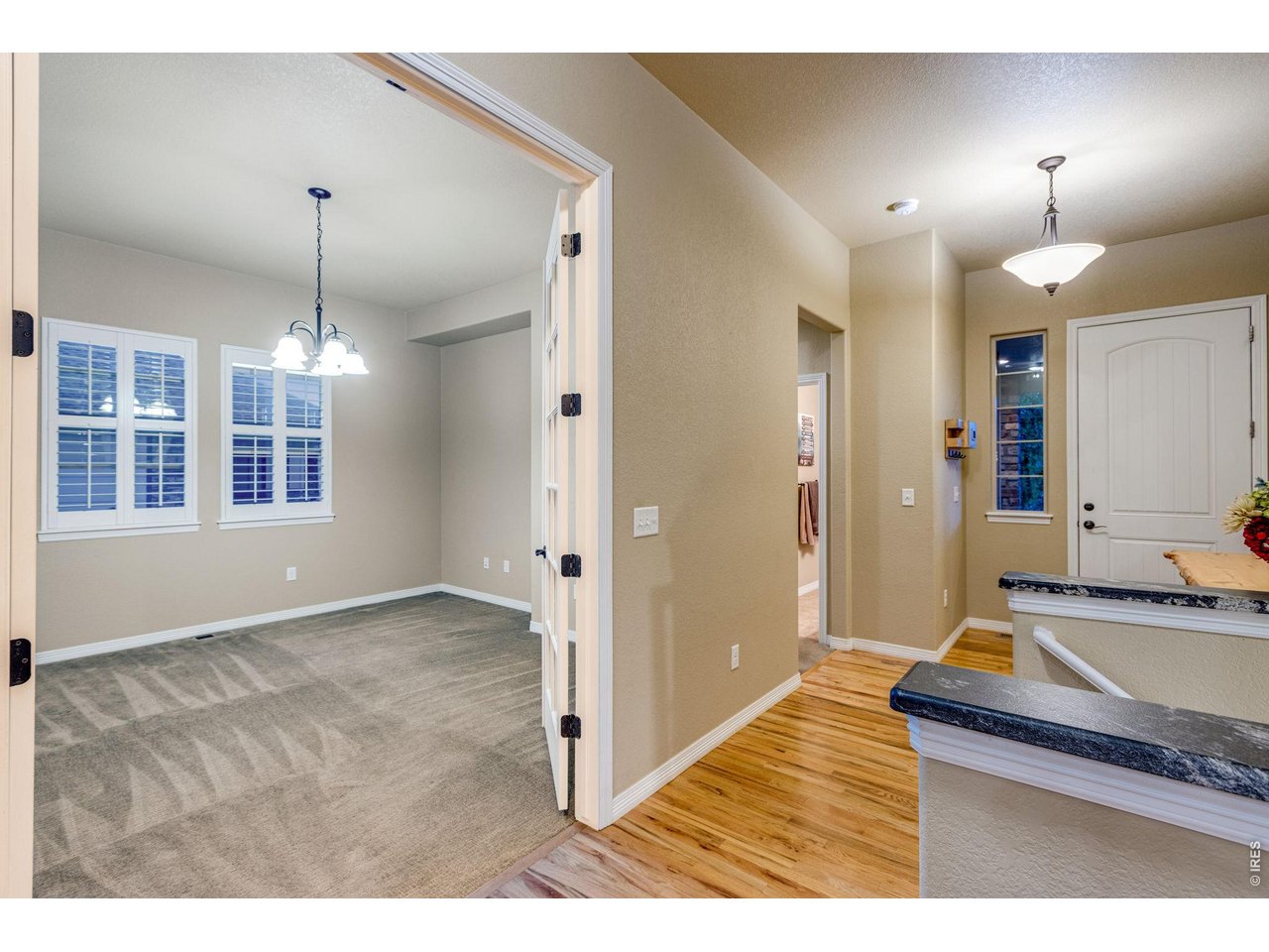 Front guest bedroom or executive office featuring plantation shutters