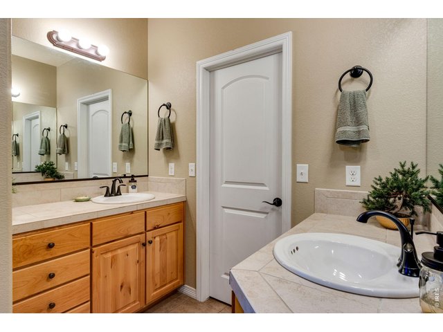 Property Photo 22 5-piece bath with tile flooring, door to throne and split vanities
