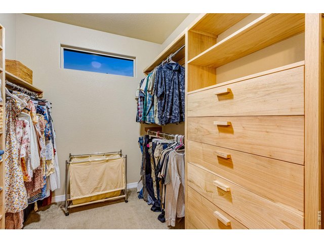 Property Photo 21 walk-in closet with built in cabinets and shelving