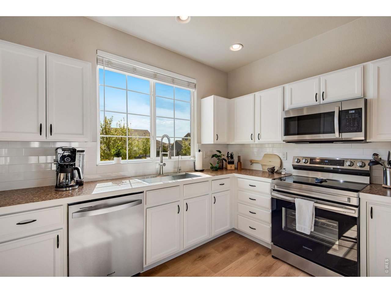 Newer Dishwasher & Disposal, Freshly painted crisp cabinetry, and interior all stainless steel appliances and separate pantry! 