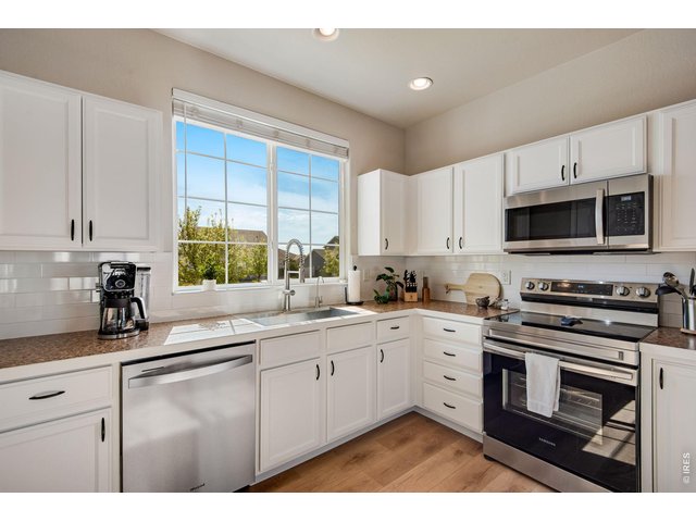 Property Photo 7 Newer Dishwasher & Disposal, Freshly painted crisp cabinetry, and interior all stainless steel appliances and separate pantry! 