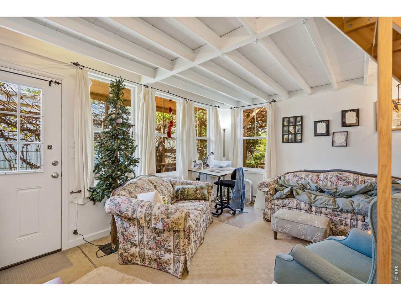 Main entry opens to study/den with beamed ceiling.