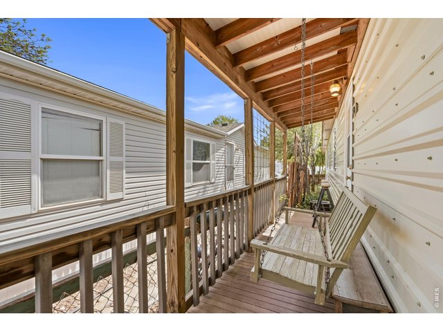 Property Photo 17 Covered deck off primary bedroom with swing.