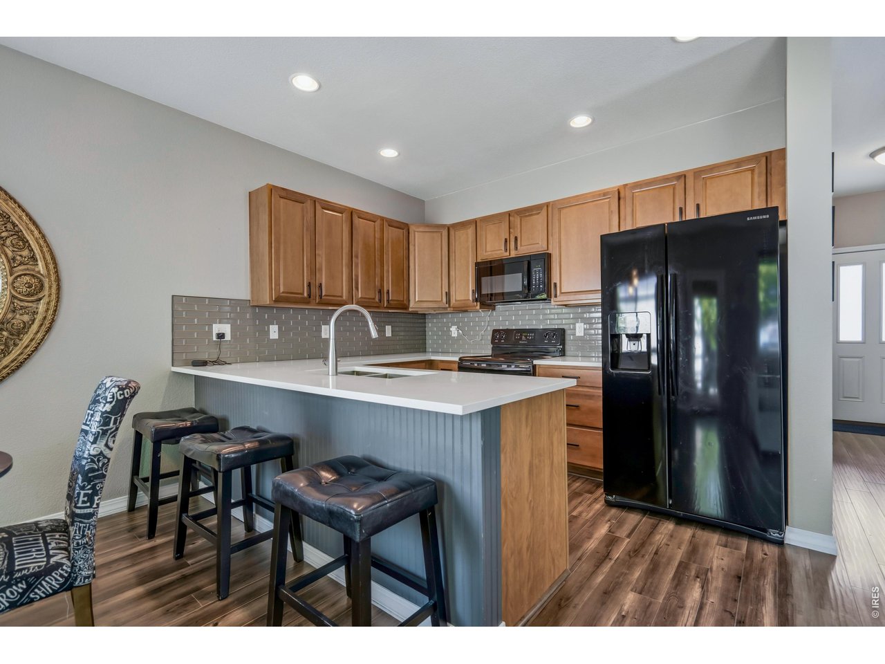 Kitchen with bar and plenty of space for 3 bar stools. 
