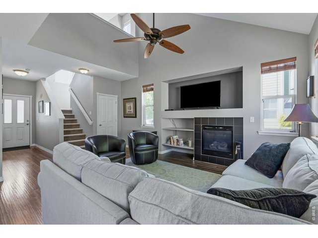 Property Photo 6 Large living room with fireplace and south and west facing windows. 
