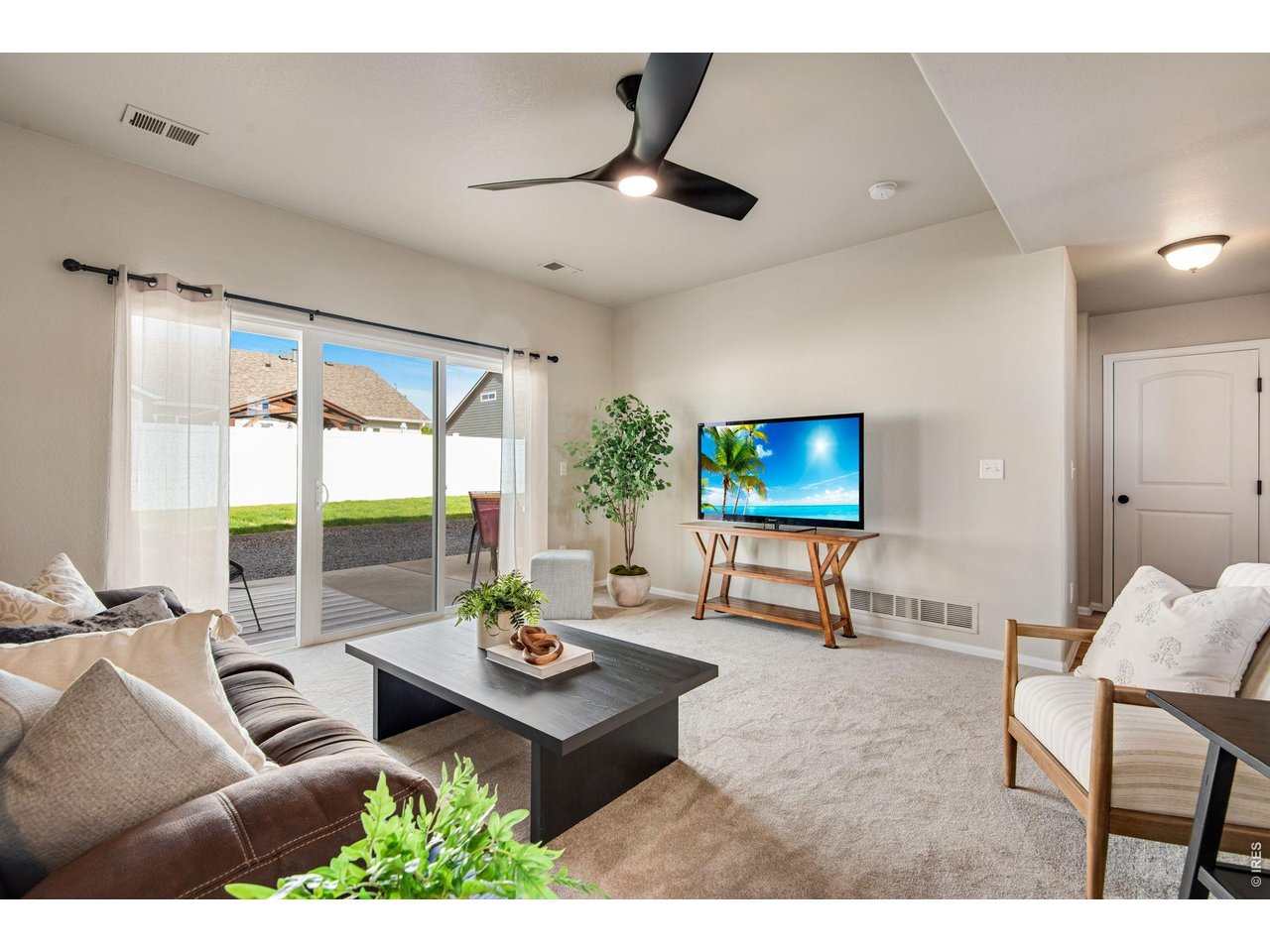 full lite, 3 panel slider opens to the large patio area, the perfect comfortable living room space. 