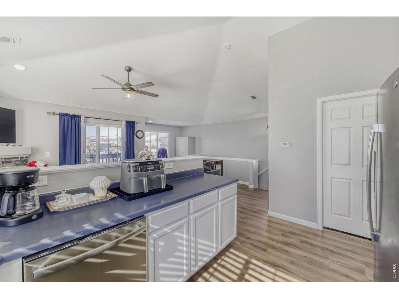 Laundry room just off the kitchen, vaulted ceilings, ceiling fans.
