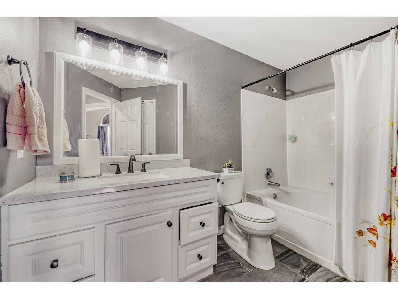 Full updated bathroom with granite counter.