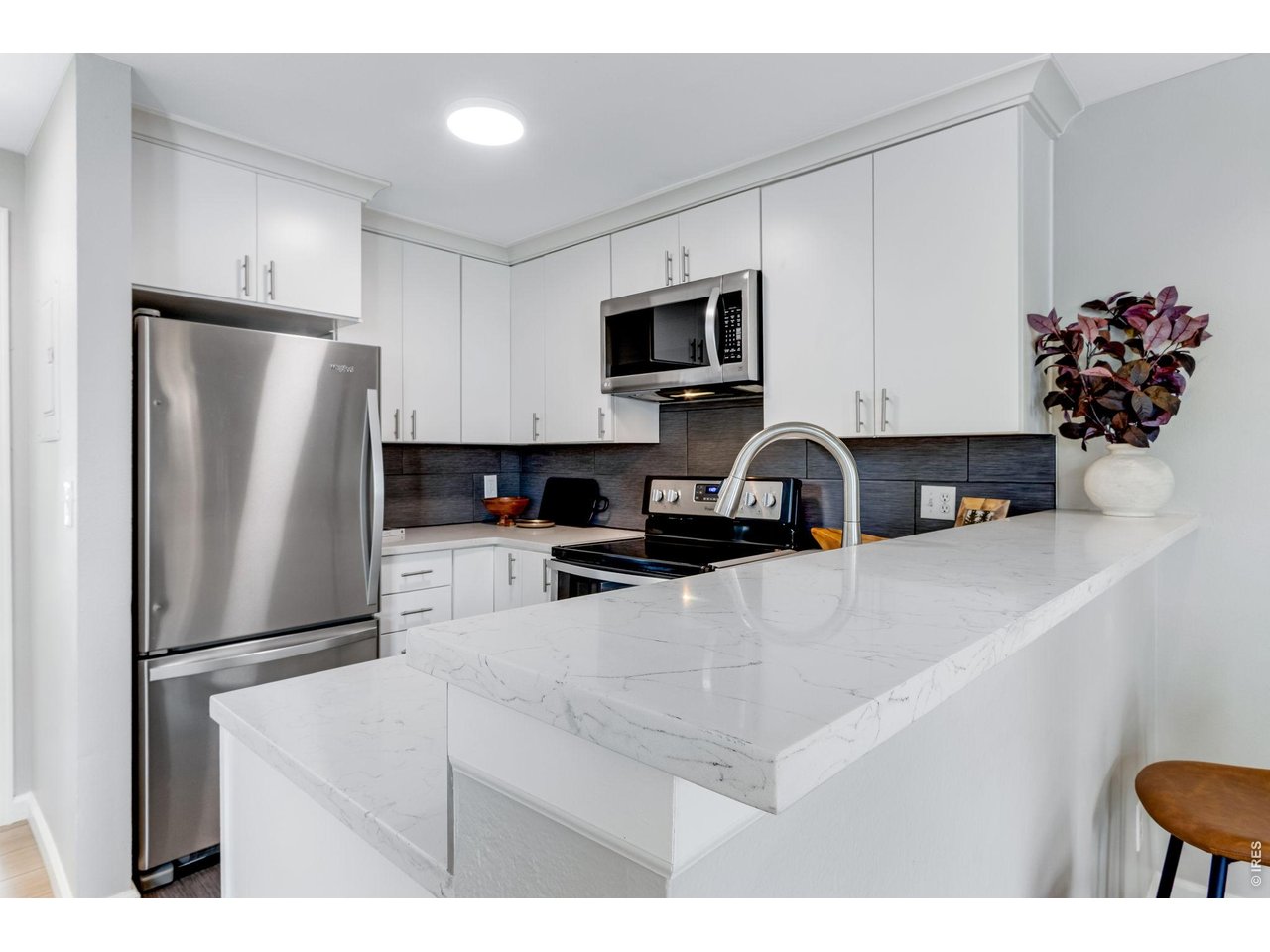 Adorable & well appointed! Chunky Quartz Countertops, all stainless appliances - modern white cabinetry with dove-tail joints, soft close full height backsplash