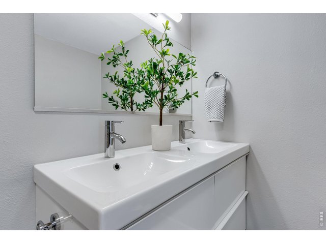 Property Photo 24 Dual sinks newer floating vanity area in the primary, new lighting, flooring, faucets, tile work!