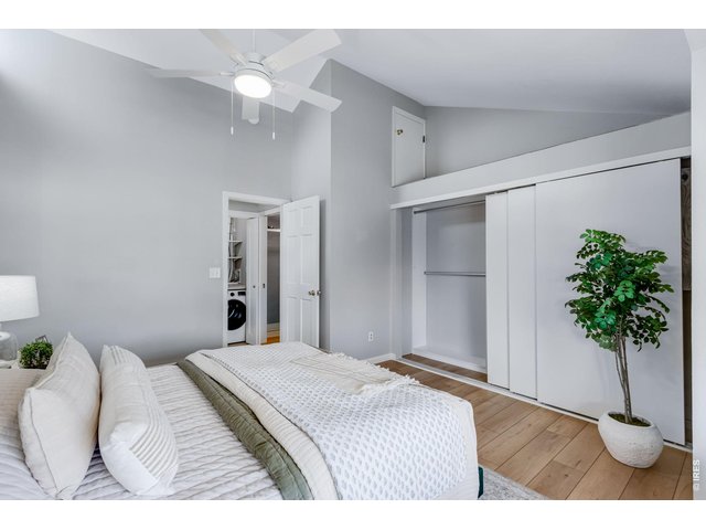 Property Photo 18 Primary Suite - vaulted ceiling & fan, upper level storage.