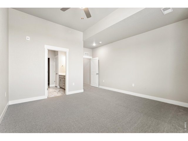 Property Photo 11 Primary bedroom with ceiling fan included!