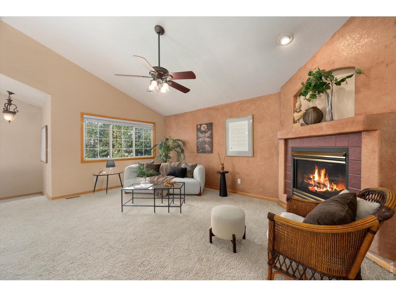 Relaxing living room with large window and glimpses of Longs Peak on clear days