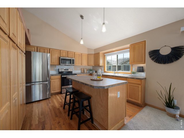 Property Photo 12 Spacious kitchen with abundant cabinetry, generous counter space, and breakfast bar